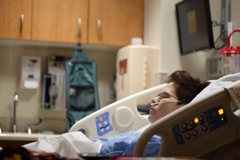 Sharon Mccutcheon hospital photo. Woman in hospital bed sleeping.