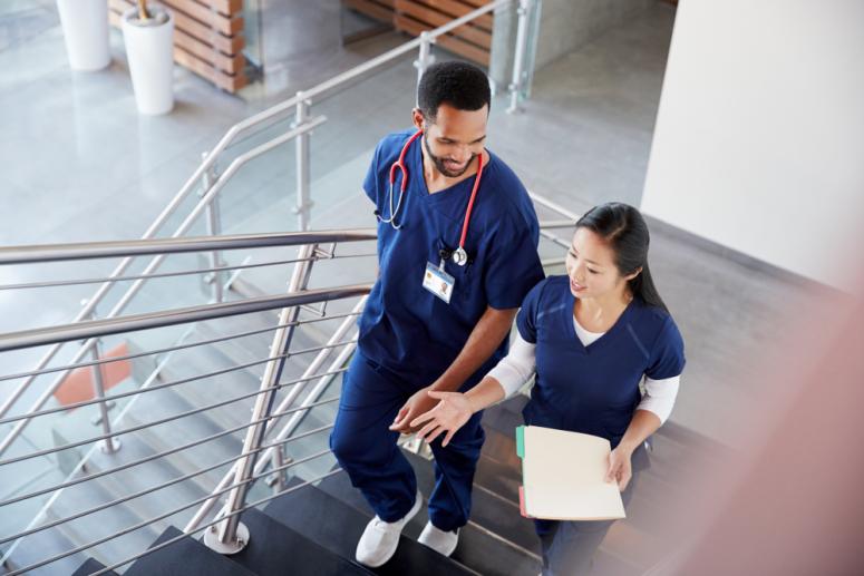 doctors walking together at hospital discussing research