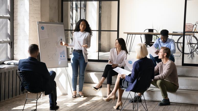 Photo of group of researchers working around a white board.