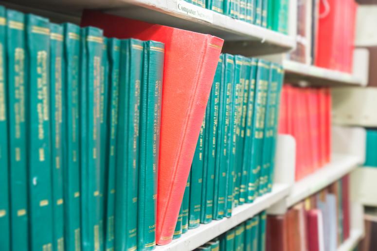 Photo of academic journals on a shelf.