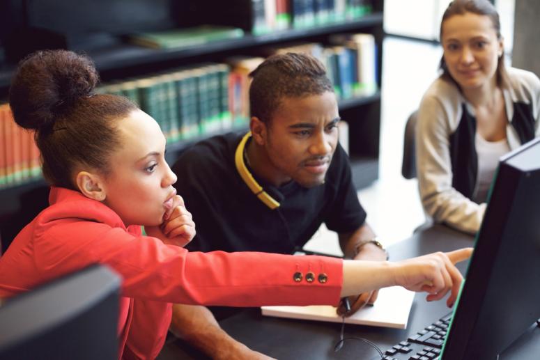 Students gathered around a computer.