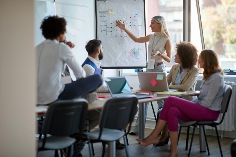 people working together at a whiteboard