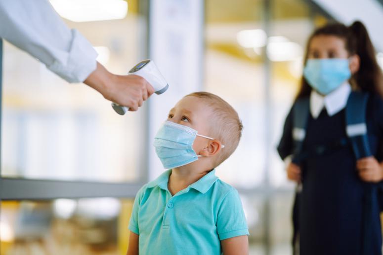 school nurse taking a student's temperature