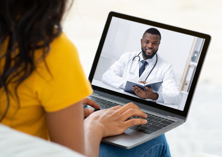 patient meeting with a Black doctor over video call