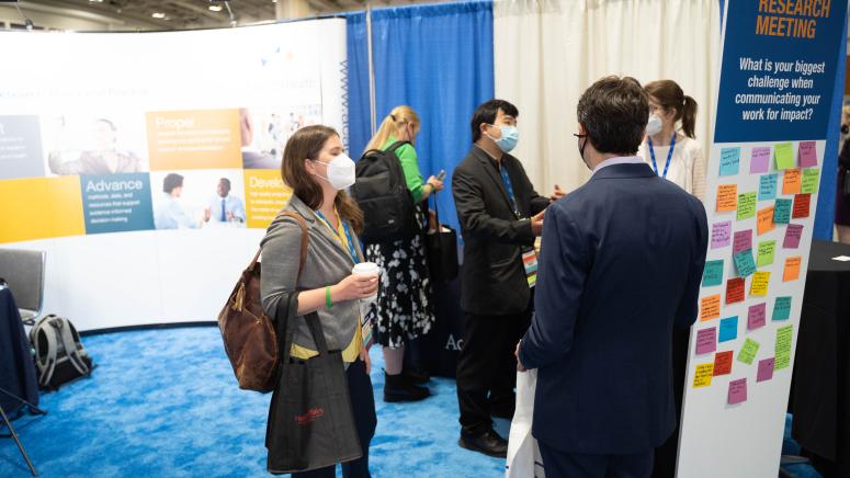 group of ARM attendees standing together at thre AH booth
