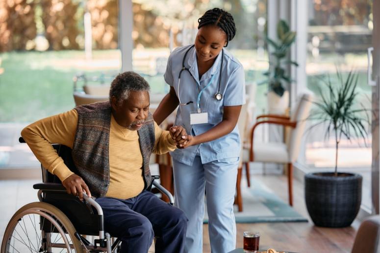 person in wheelchair being helped by nurse