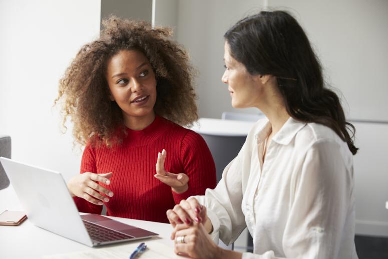 Women talking over computer